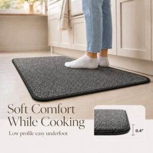 Person in socks on a low profile charcoal grey kitchen mat, showing the 0.4 inch soft comfort of the set while cooking.