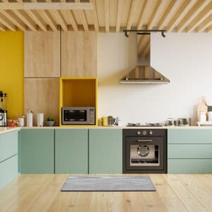 9- Gray anti-fatigue kitchen runner mat on a wood floor in a colorful modern kitchen.
