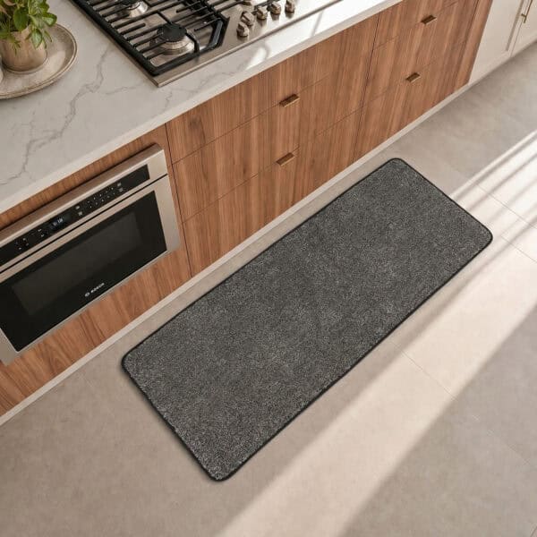 Charcoal grey kitchen runner laid along the counter in a modern kitchen, adding cool neutral contrast to the floor.