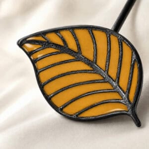 Macro view of the yellow stained-glass resin leaf with raised veins