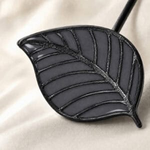 Macro view of the gray stained-glass resin leaf with raised veins