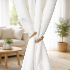 "Jute rope tieback holding white curtain panels together in a bright living room"