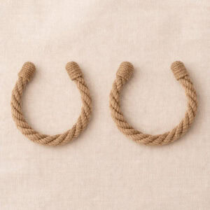 "Jute twisted rope tiebacks in U-shape on fabric surface"