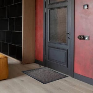 Tan low profile entry mat placed indoors near door