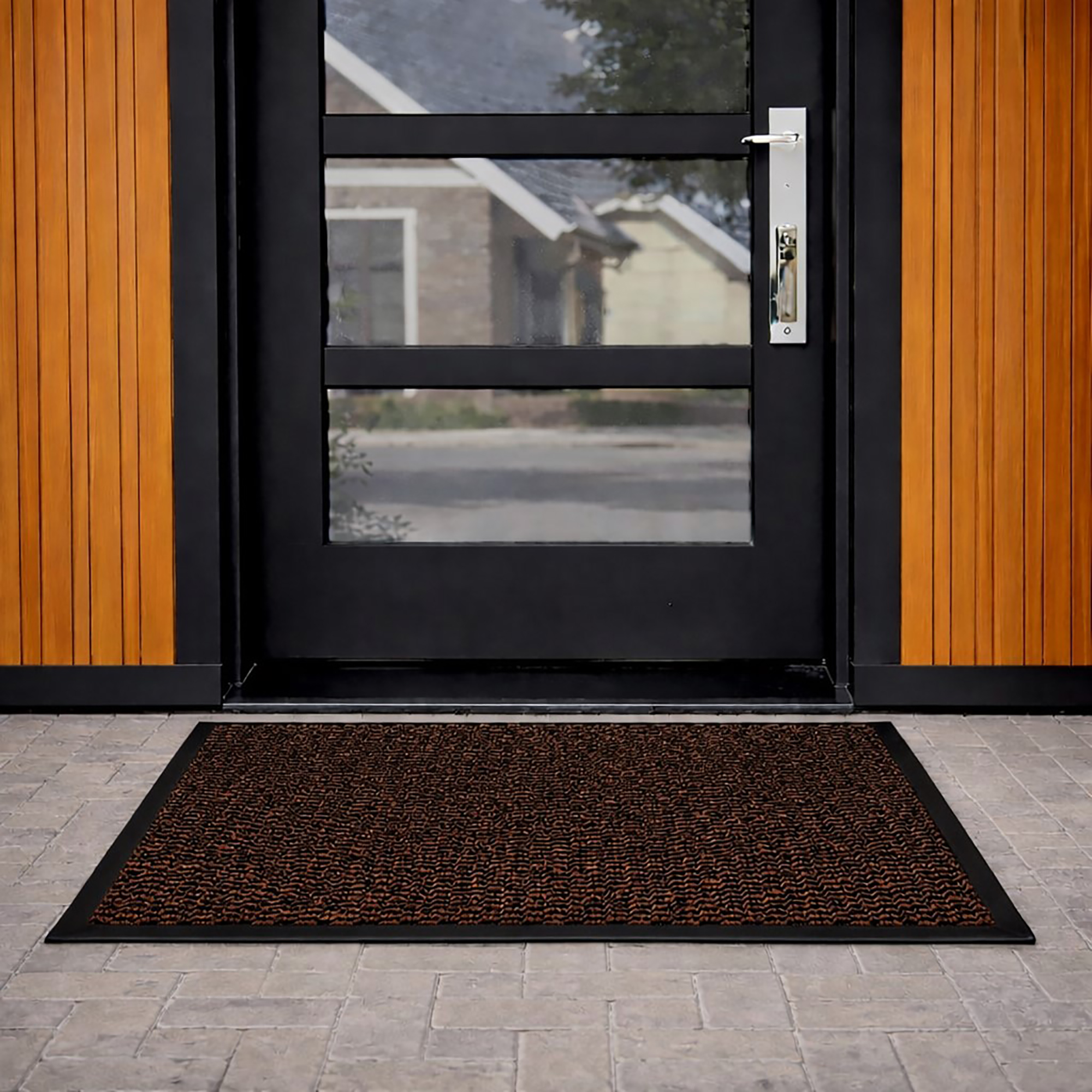 Tan door mat in front of modern glass exterior door