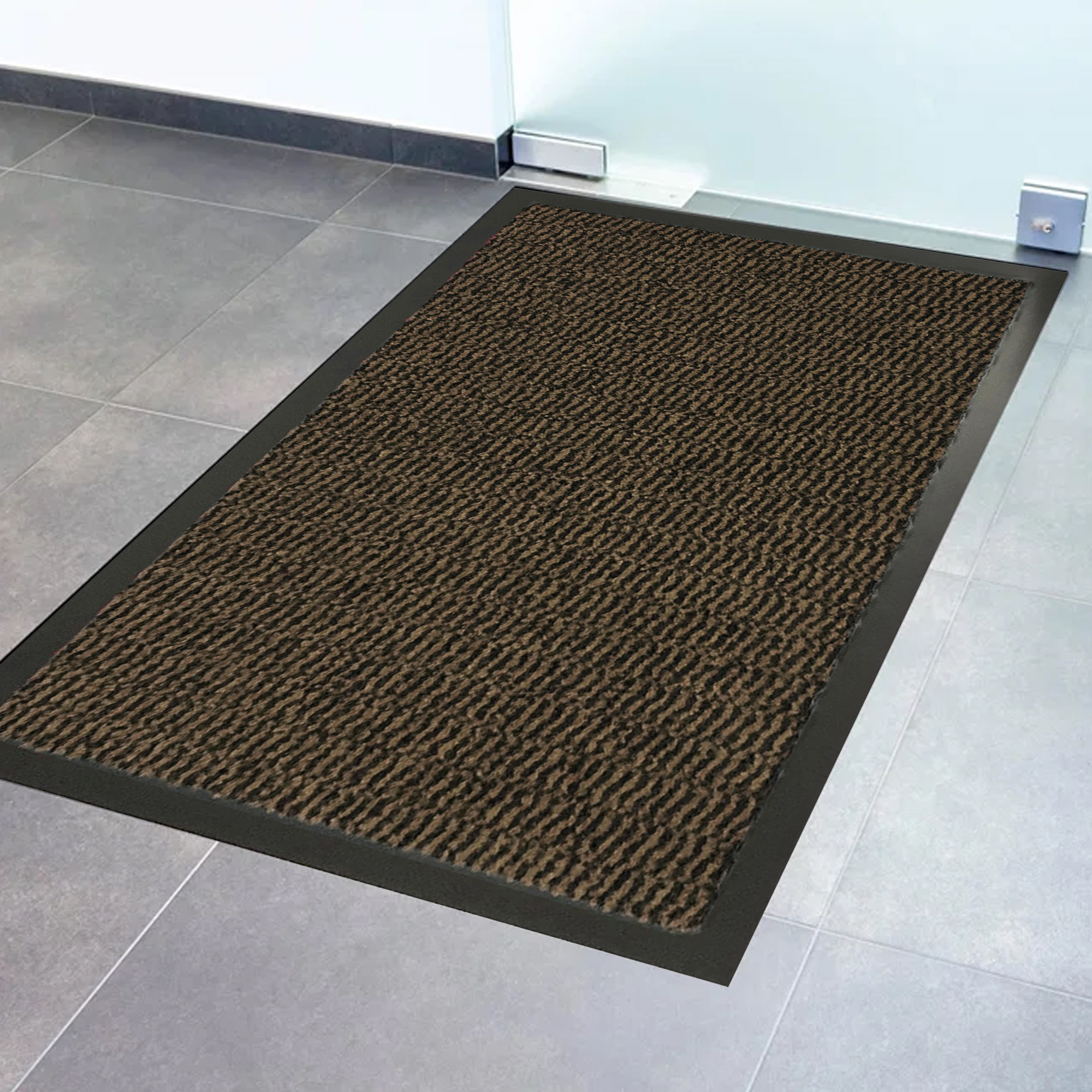 Close-up of tan textured door mat surface with black non-slip border