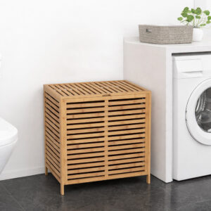 Bamboo slatted laundry hamper with lid closed, placed next to a washing machine in a laundry room