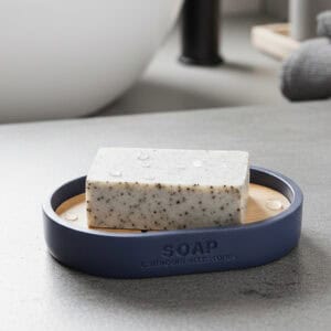 Navy blue bathroom accessory set with bamboo accents on marble counter
