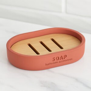 Terracotta oval soap dish with slotted bamboo insert on countertop