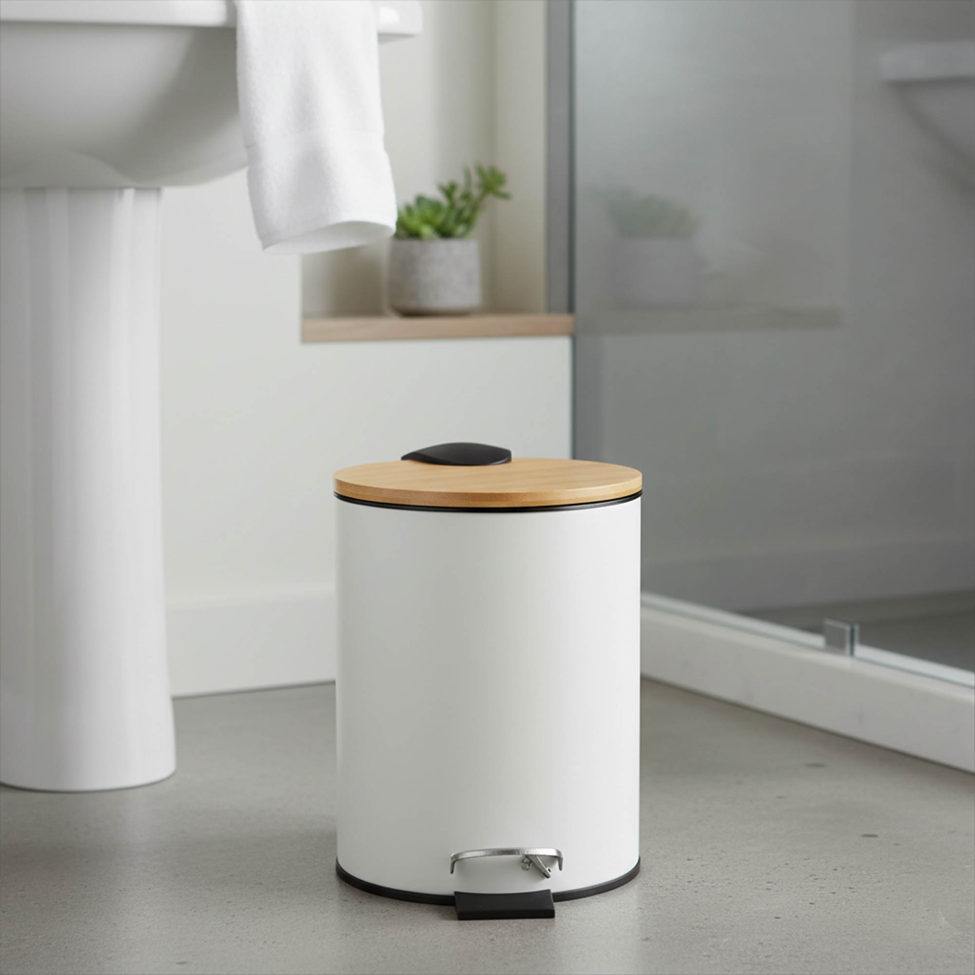 White step trash can with bamboo lid and foot pedal beside sink and shower