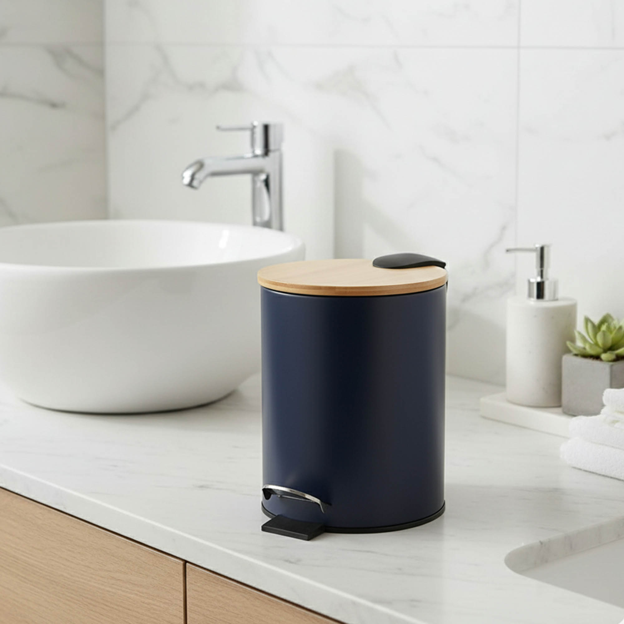 Navy blue step trash can with bamboo lid on bathroom countertop