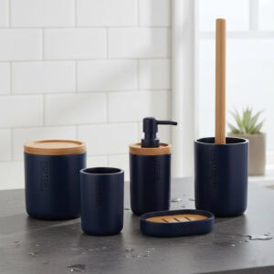 Navy blue bathroom accessory set with bamboo lids and accents displayed on wet countertop