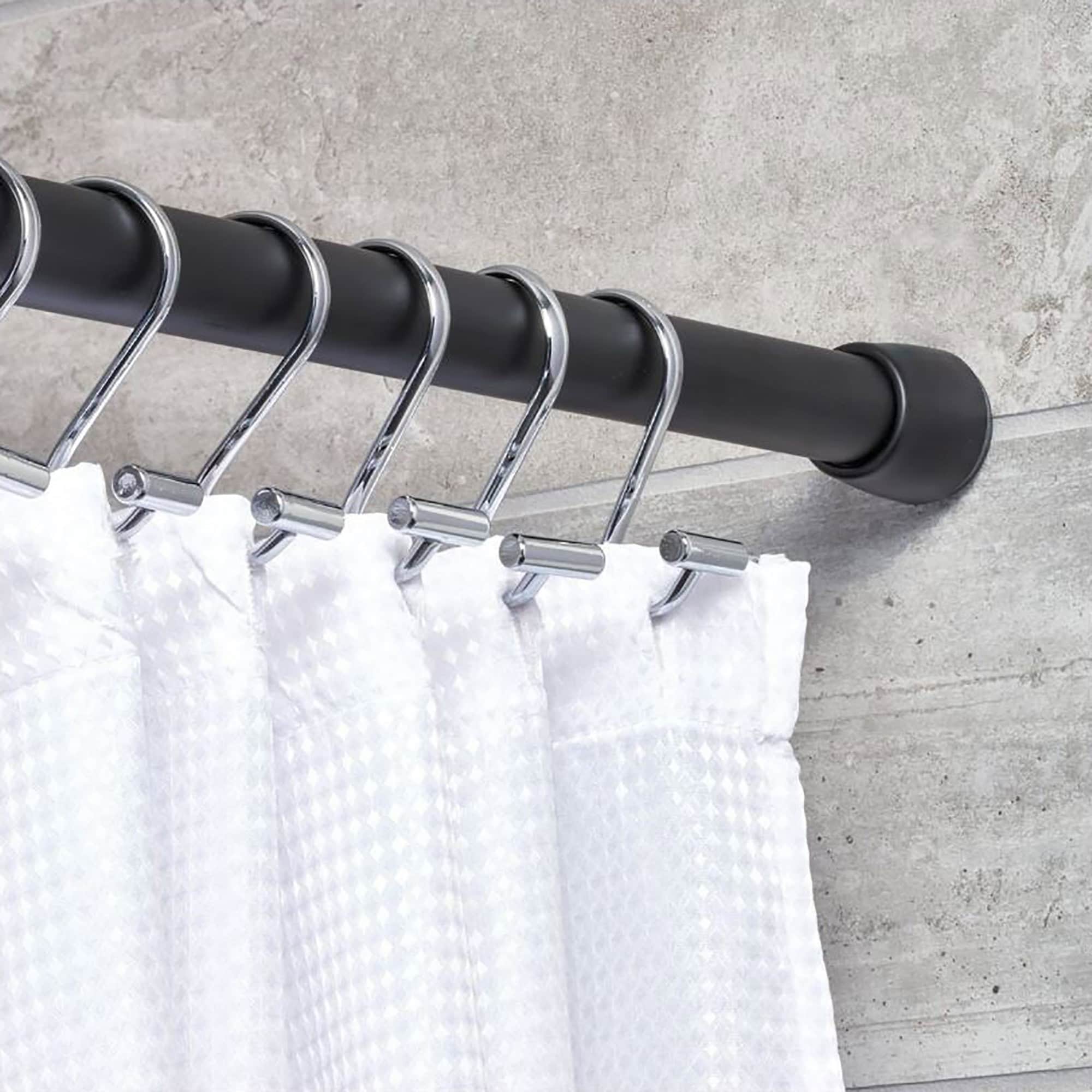 Shower Rod Display with Curtain Rings in Bathroom Setting: A black shower curtain rod installed in a bathroom, holding a curtain with decorative silver rings.