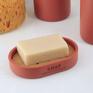 Terracotta soap dish with bamboo slotted insert holding a standard bar of soap.
