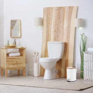 A white step trash can with a bamboo lid placed in a bathroom with natural wood accents, complementing the serene and modern décor.