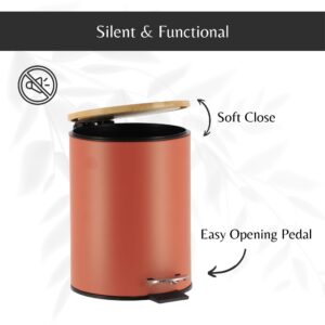 Open terracotta trash can showing the soft-close bamboo lid and the easy-to-use black foot pedal for convenient trash disposal.