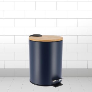A navy blue step trash bin with a bamboo lid and soft-close feature, placed in a tiled bathroom setting.