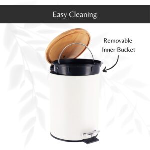 White step trash can with its bamboo lid open, revealing a removable inner bucket with a handle for hassle-free cleaning and maintenance.