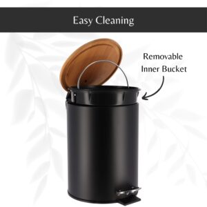 Black step trash can with its bamboo lid open, revealing a removable inner bucket with a handle for hassle-free cleaning and maintenance.