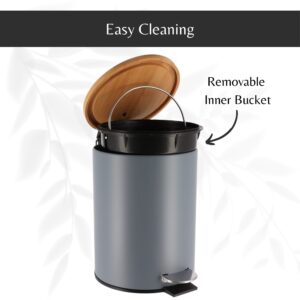 Gray step trash can with its bamboo lid open, revealing a removable inner bucket with a handle for hassle-free cleaning and maintenance.