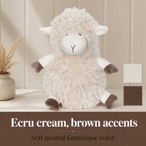 Cream sheep door stopper on a cream surface beside two fabric swatches (cream and brown), with dried grass in a vase. On-image text: "Ecru cream, brown accents," "Soft neutral farmhouse color."
