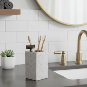 Gray stone effect toothbrush holder with bamboo brushes on vanity