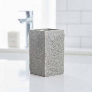 Single gray stone effect bathroom tumbler on white countertop