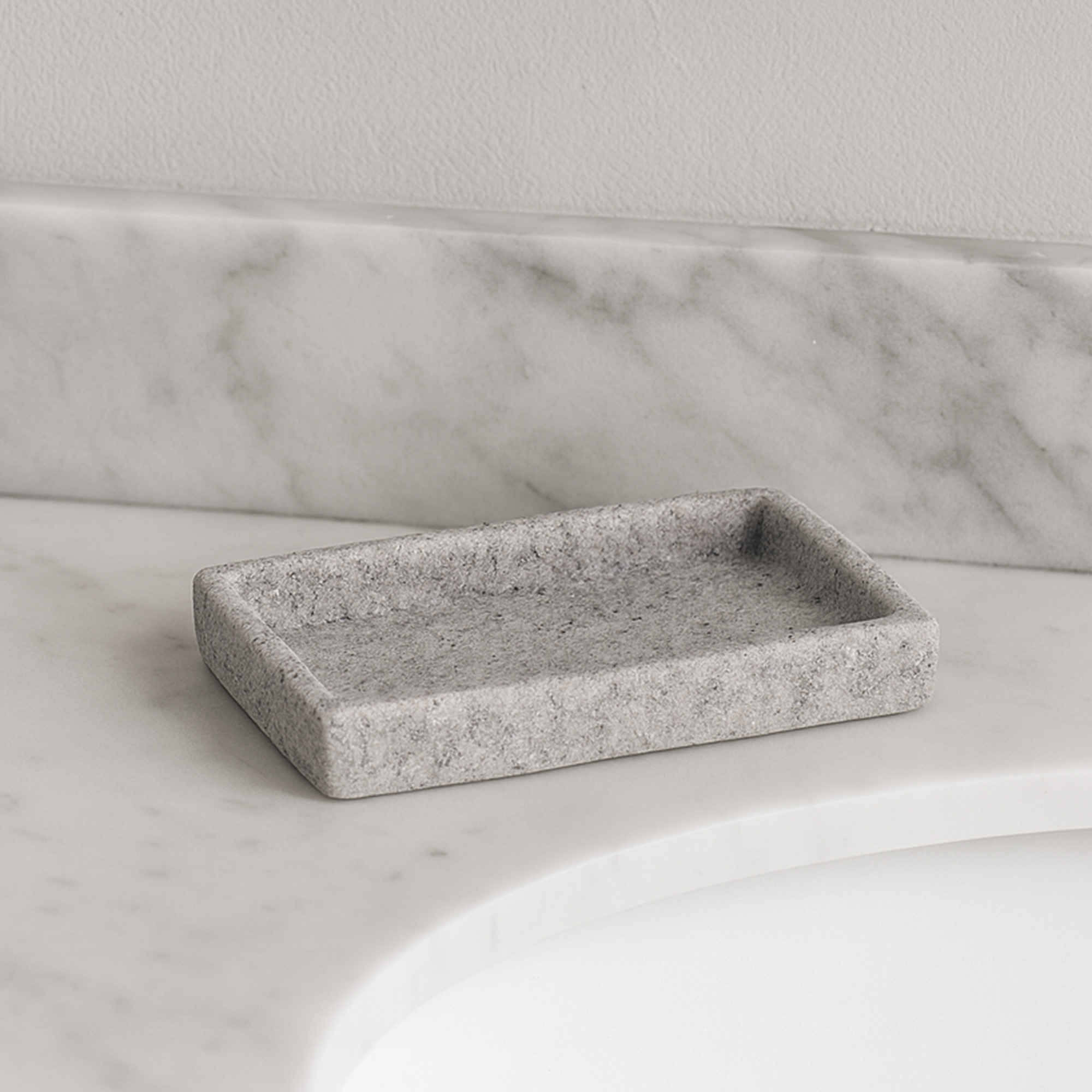 Gray stone effect rectangular soap dish on marble vanity