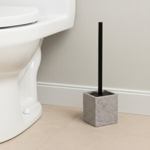 Gray stone effect toilet brush holder with black handle beside white toilet