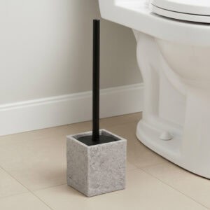 Gray stone effect toilet brush holder next to white toilet