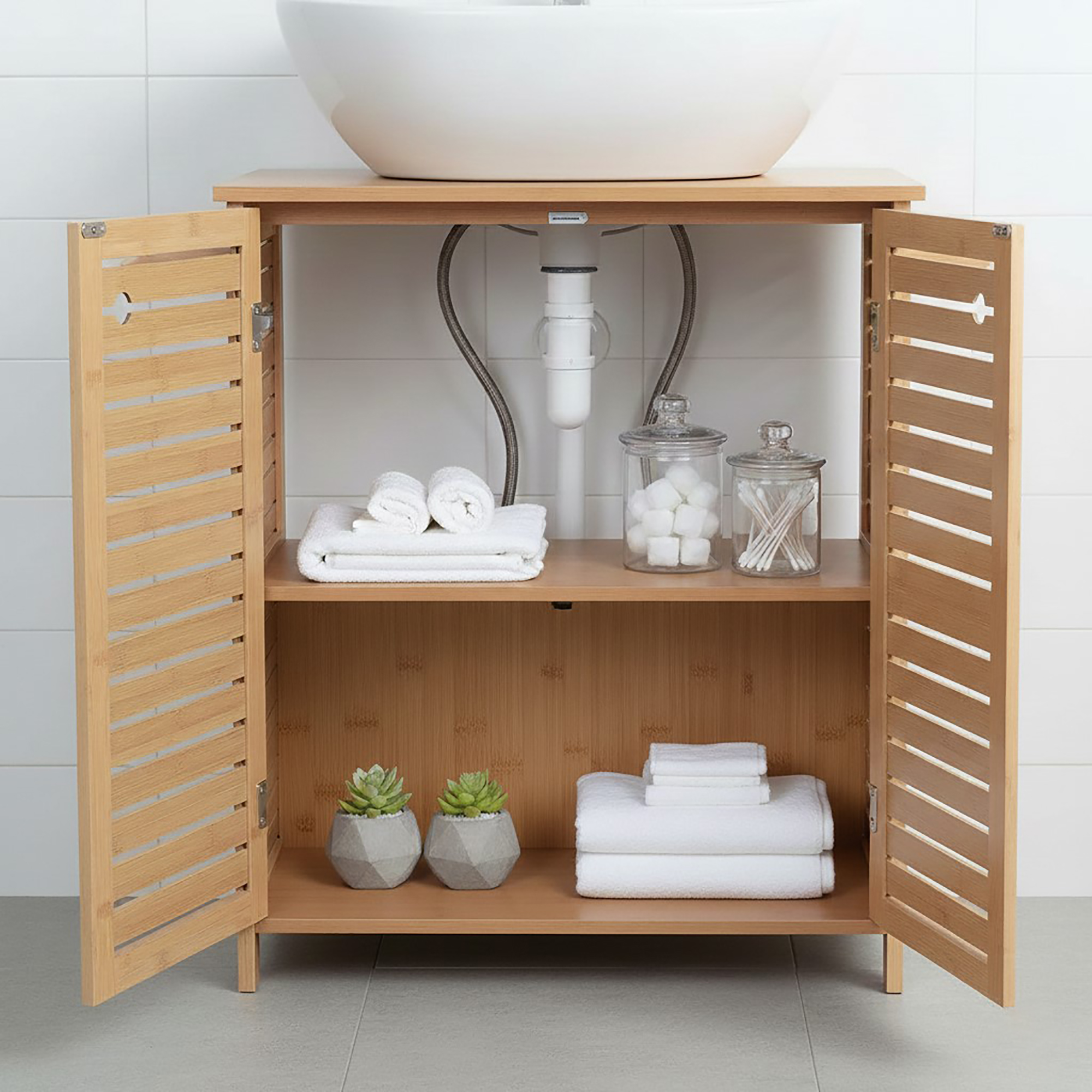 “Open bamboo under-sink bathroom cabinet showing interior shelf with towels and accessories”