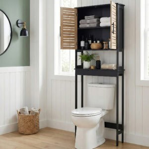 “Black over-the-toilet cabinet with wood-look doors open showing organized shelves in bright bathroom”
