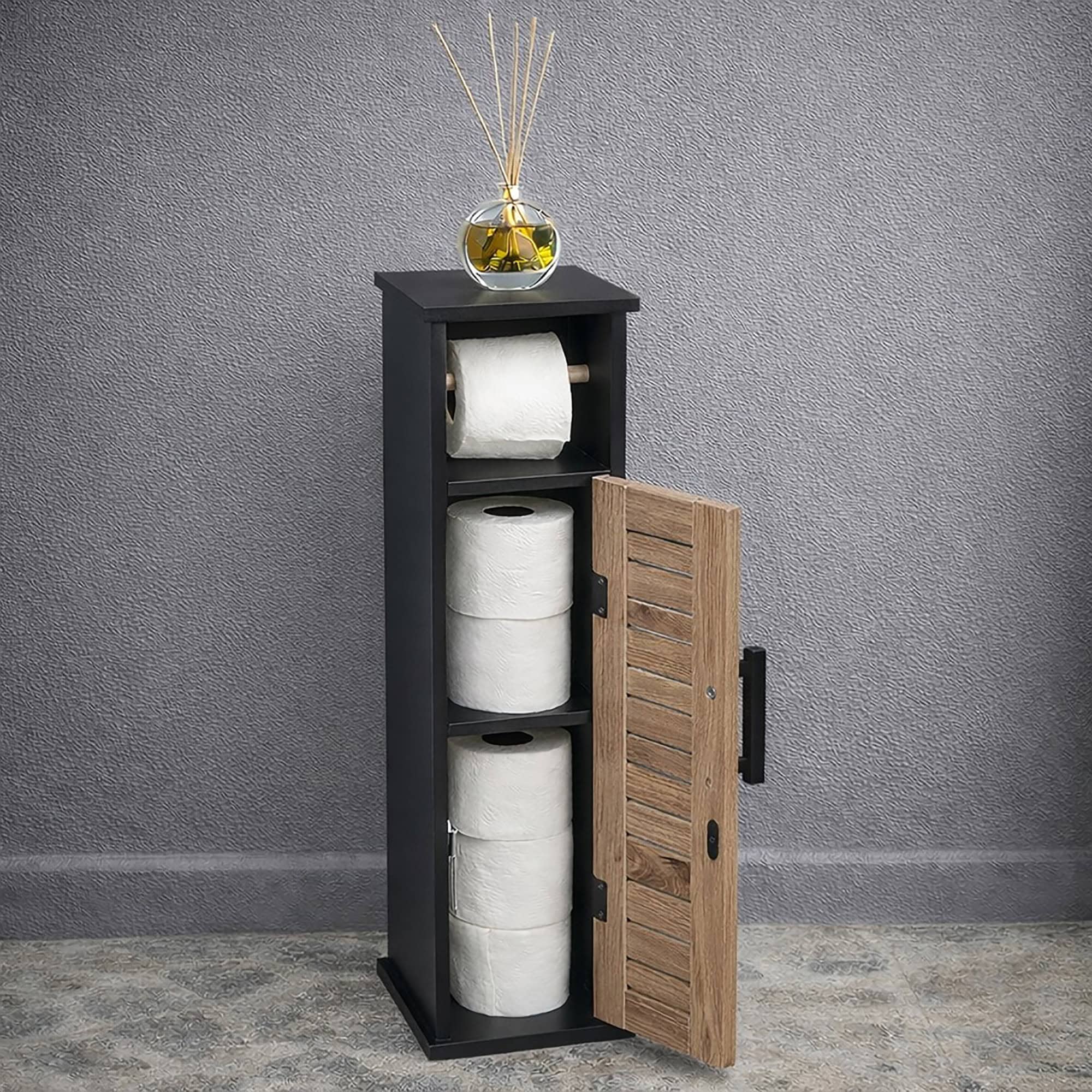 Freestanding toilet paper holder with storage cabinet in black, featuring a slatted wood door and space for multiple rolls.