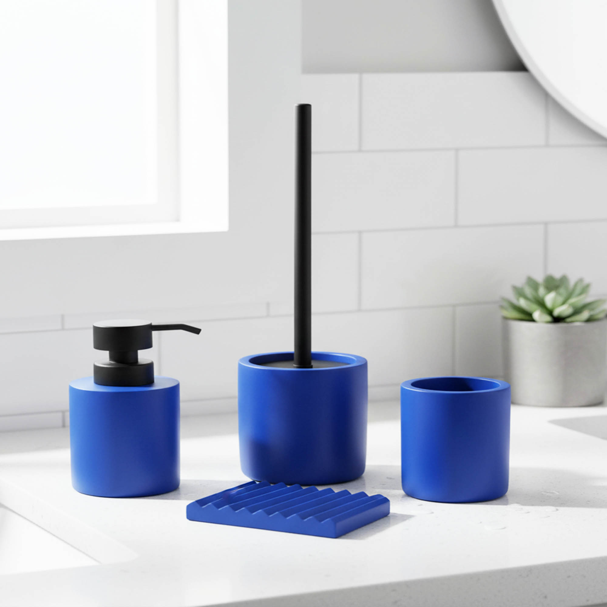 Blue bathroom accessory set with soap dispenser tumbler toilet brush holder on counter