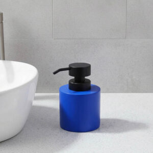Blue soap dispenser with black pump on bathroom vanity close-up