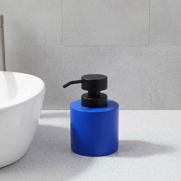Blue soap dispenser with black pump on bathroom vanity close-up