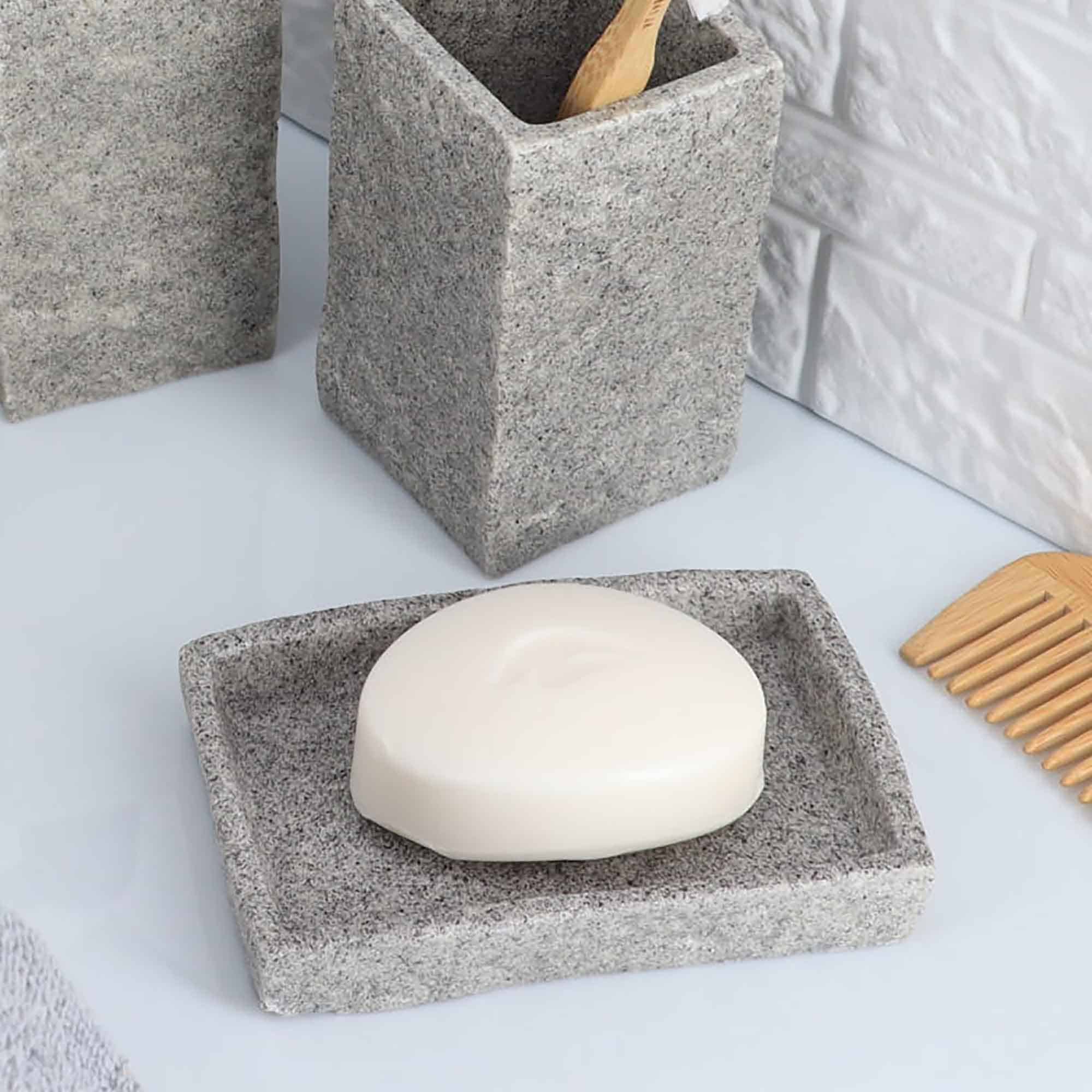 A close-up of a gray stone-effect rectangular soap dish showcasing its minimalist design and smooth texture.