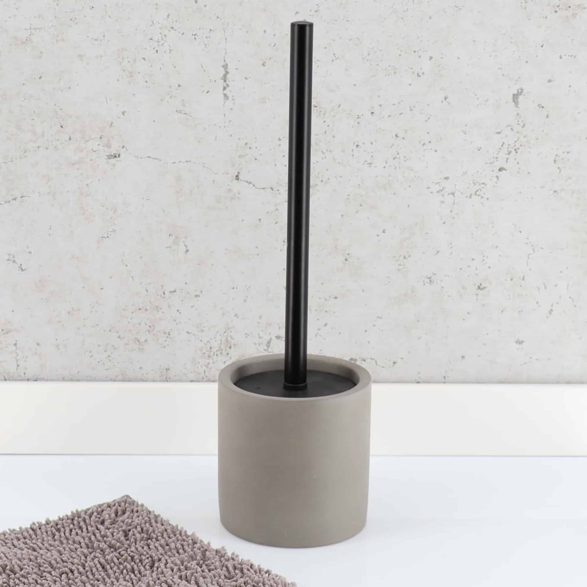 Toilet Brush in Bathroom: Gray toilet brush in a bathroom setting.