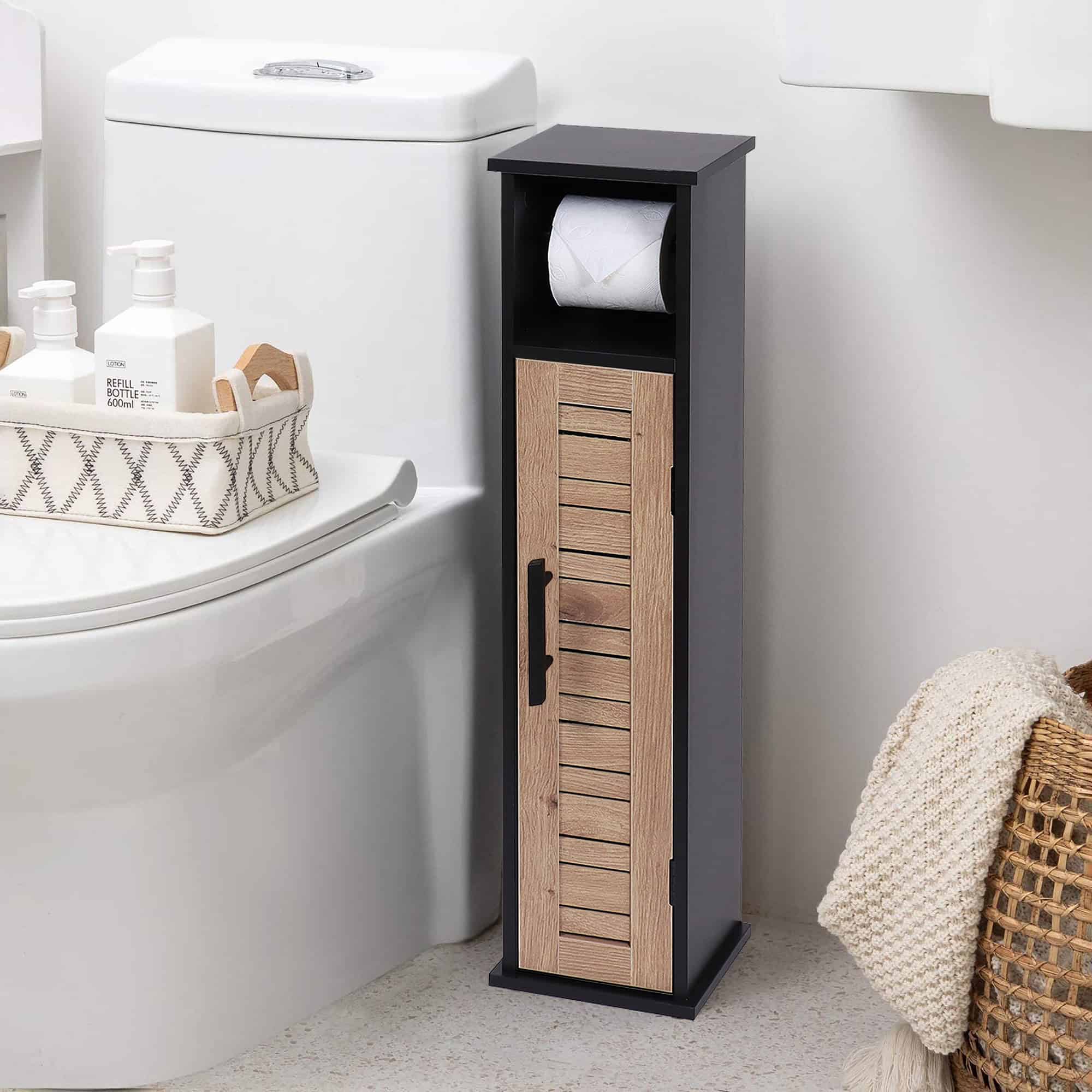 The cabinet placed next to a toilet, holding a roll of toilet paper and bathroom accessories.