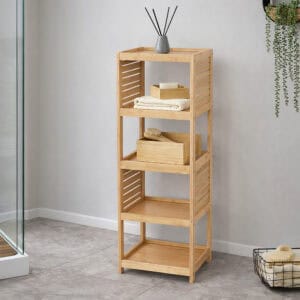 A bamboo shelf holding towels and decor in a stylish bathroom.
