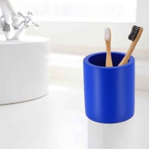 Minimalist blue toothbrush holder on a white sink