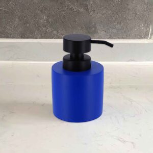 Minimalist blue soap dispenser on a white sink
