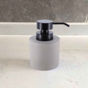 Minimalist gray soap dispenser on a white sink