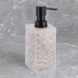 A gray stone-effect soap dispenser with a black pump, set against a textured marble background for a modern aesthetic.