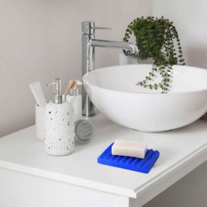 Minimalist Soap Dish: Blue soap dish on a clean bathroom sink.