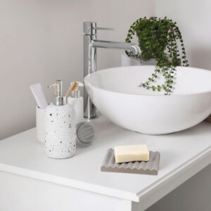 Minimalist Soap Dish: Gray soap dish on a clean bathroom sink.
