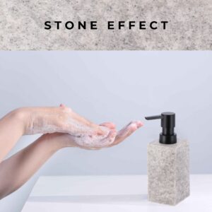 A demonstration of handwashing with soap lather, accompanied by a gray stone-effect soap dispenser featuring a black pump on a clean countertop.