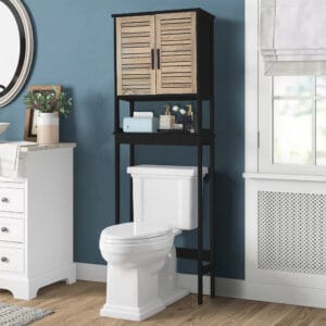 “Black over-the-toilet storage cabinet with wood-look doors displayed in blue bathroom”