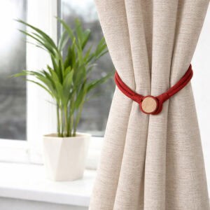 Red magnetic curtain tieback securing a beige curtain