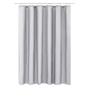 Light gray shower curtain hanging on a rod